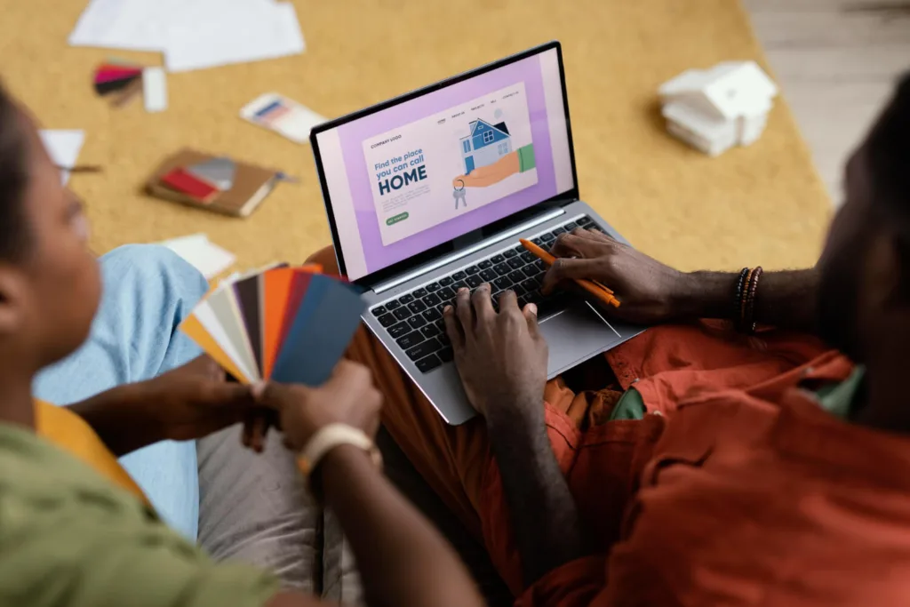 Couple making plans for content migration using color palette and laptop